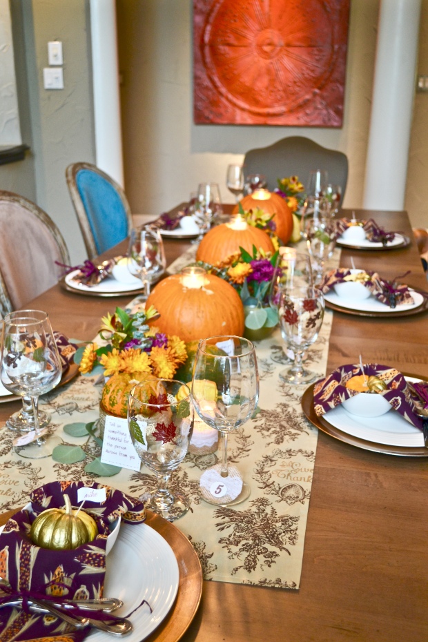 {Fun, Yum & Frills} Classic tan and gold table runner accompanied by a bright purple and orange corn husk themed napkins for a colorful Thanksgiving tablescape on funyumandfrills.com