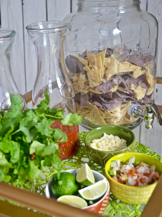 {Fun, Yum & Frills} A unique spin on a Cinco de Mayo bar cart by subbing out the alcohol and bar items to create a fun chips and salsa cart! #mexicanfood #cincodemayoparty